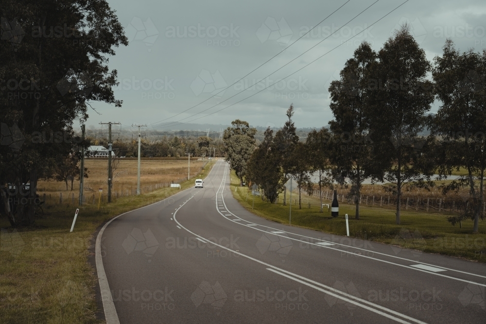 White van driving down a country road in the Hunter Valley Wine Region - Australian Stock Image