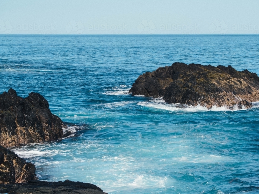 White water surrounding seaside rocks - Australian Stock Image