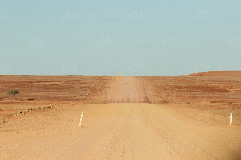 Wide outback dirt road with blue sky - Australian Stock Image