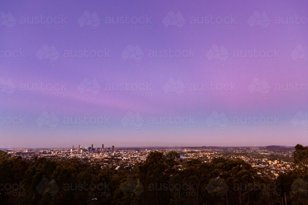 Image of wide shot of Brisbane and suburbs at dusk - Austockphoto