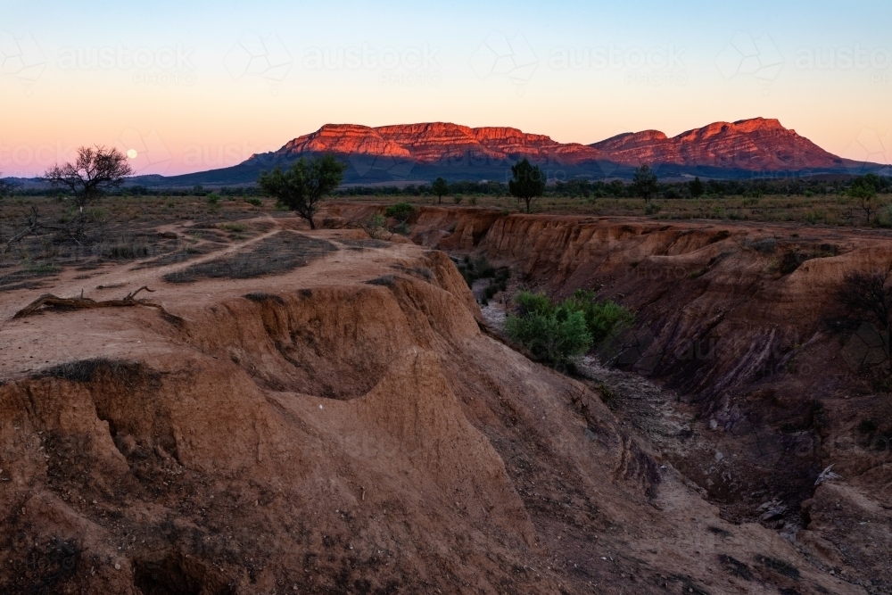 Wilpena Pound lit by rising sun - Australian Stock Image