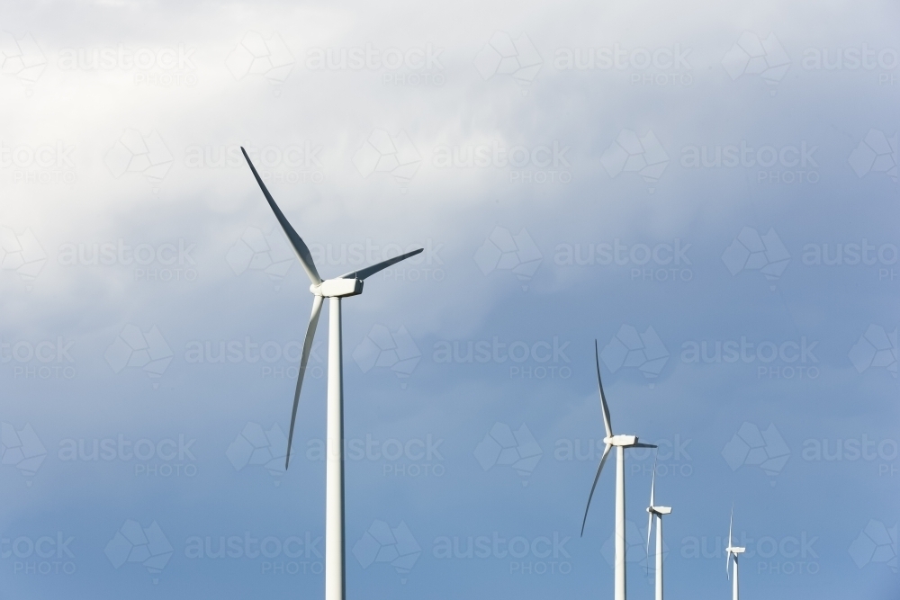 Wind turbines against a stormy sky - Australian Stock Image