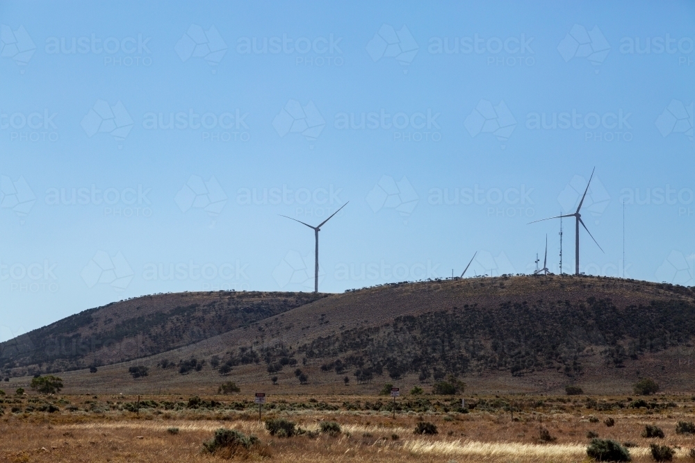 Wind turbines along ridge line at a wind farm. - Australian Stock Image