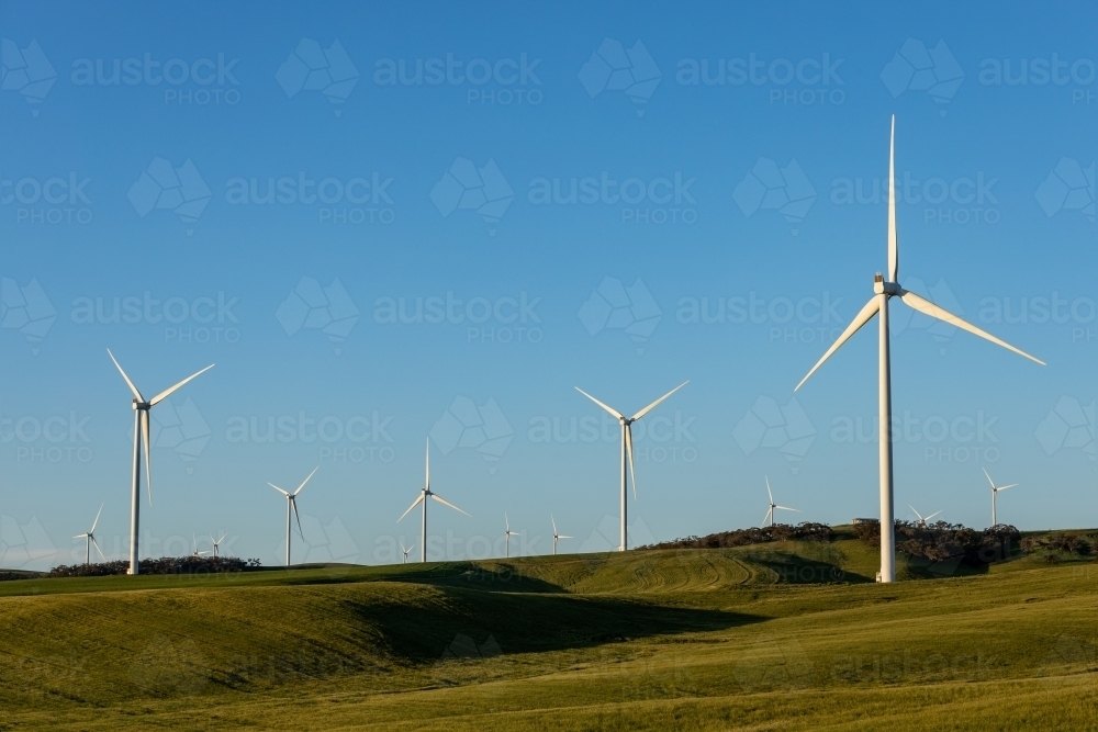 wind turbines on rolling farm land - Australian Stock Image