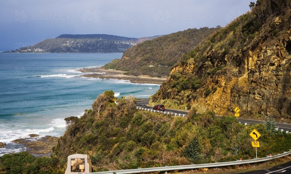 Winding coastal road cut into steep cliffs - Australian Stock Image