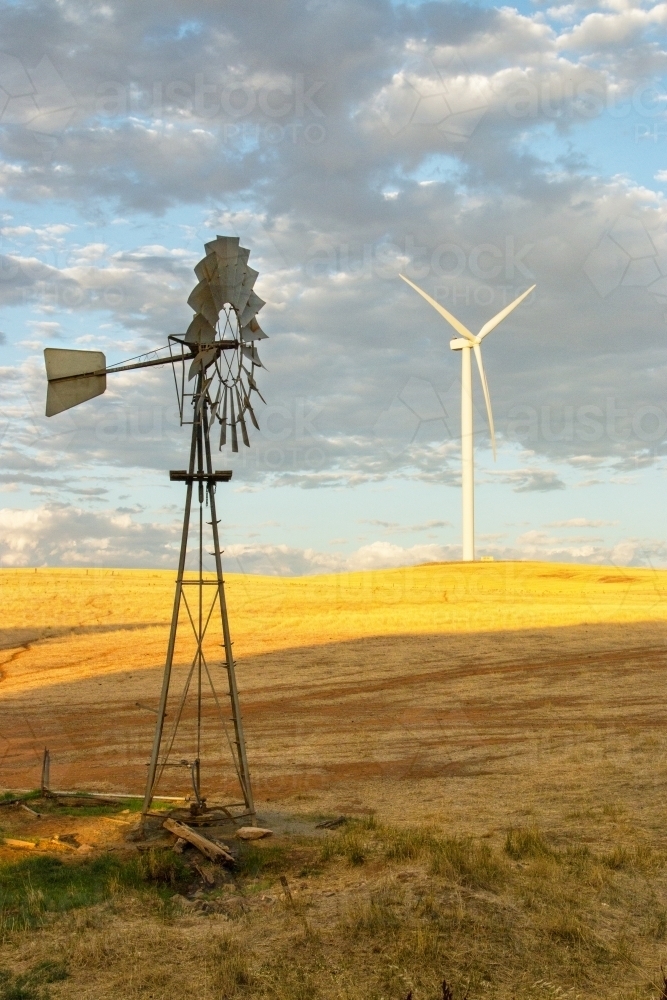 Windmill in front with wind turbine in the background - Australian Stock Image