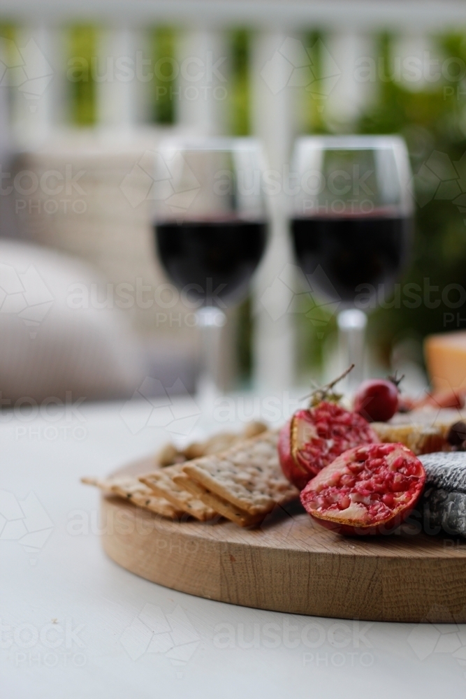 Wine glassses with cheese and cracker platter - Australian Stock Image