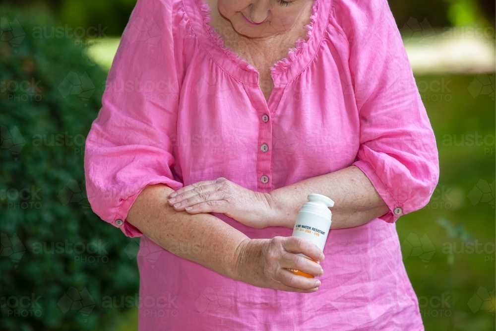 Woman applying sunscreen - Australian Stock Image