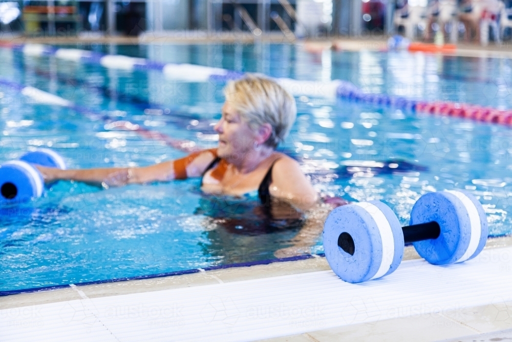 Woman doing hydrotherapy exercises in local town pool - Australian Stock Image