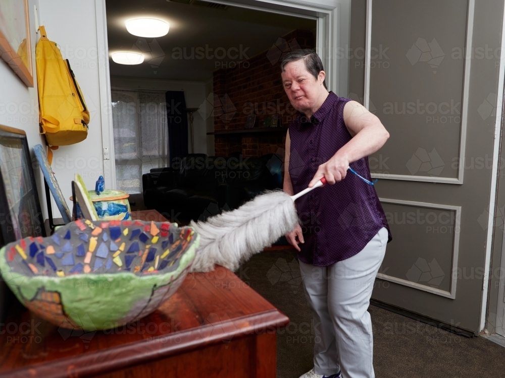 Woman Dusting at Home - Australian Stock Image