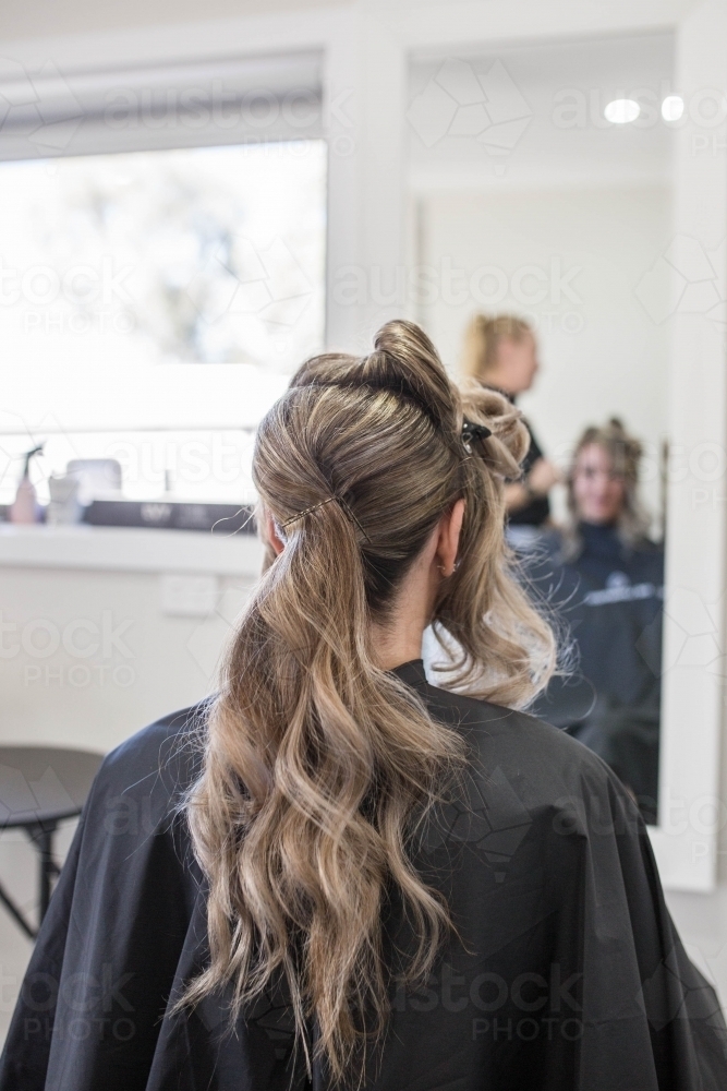 Woman getting hair done at hairdressing salon - Australian Stock Image