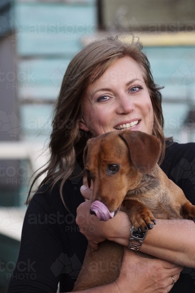 Woman holding dog close up - Australian Stock Image