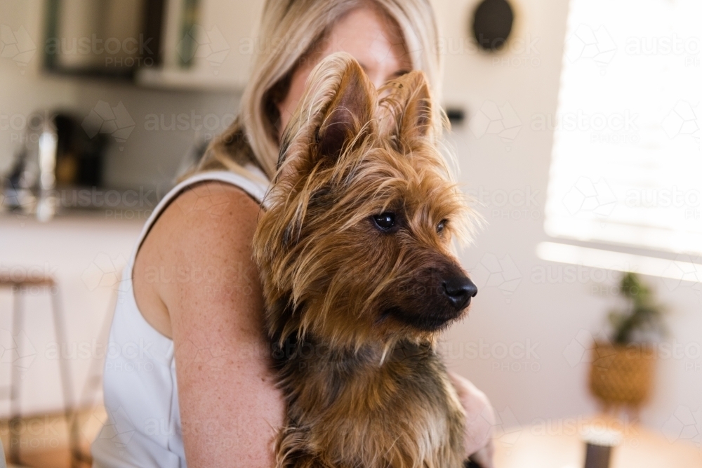 woman hugging her dog - Australian Stock Image