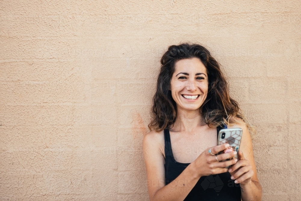 woman in the city, using phone - Australian Stock Image