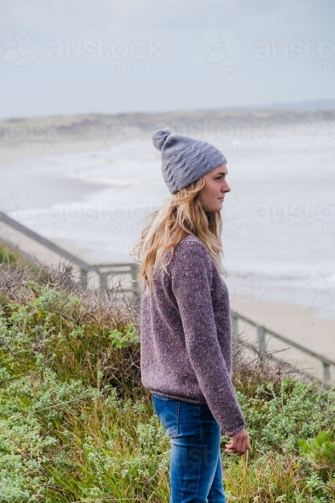 Woman on the cliff tops by the ocean. - Australian Stock Image