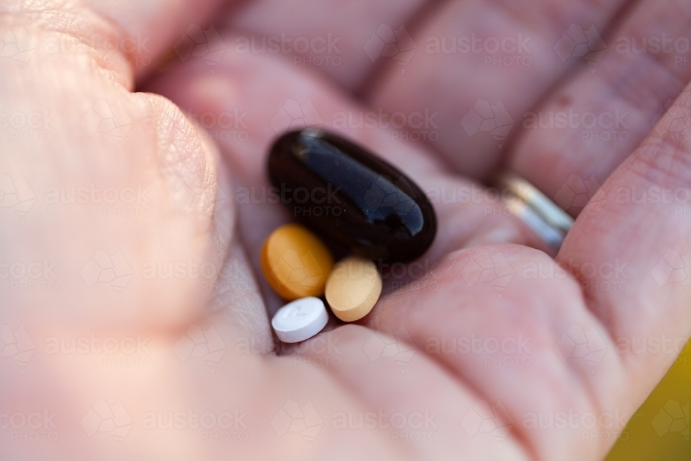 woman's hand holding pregnancy tablets - Australian Stock Image