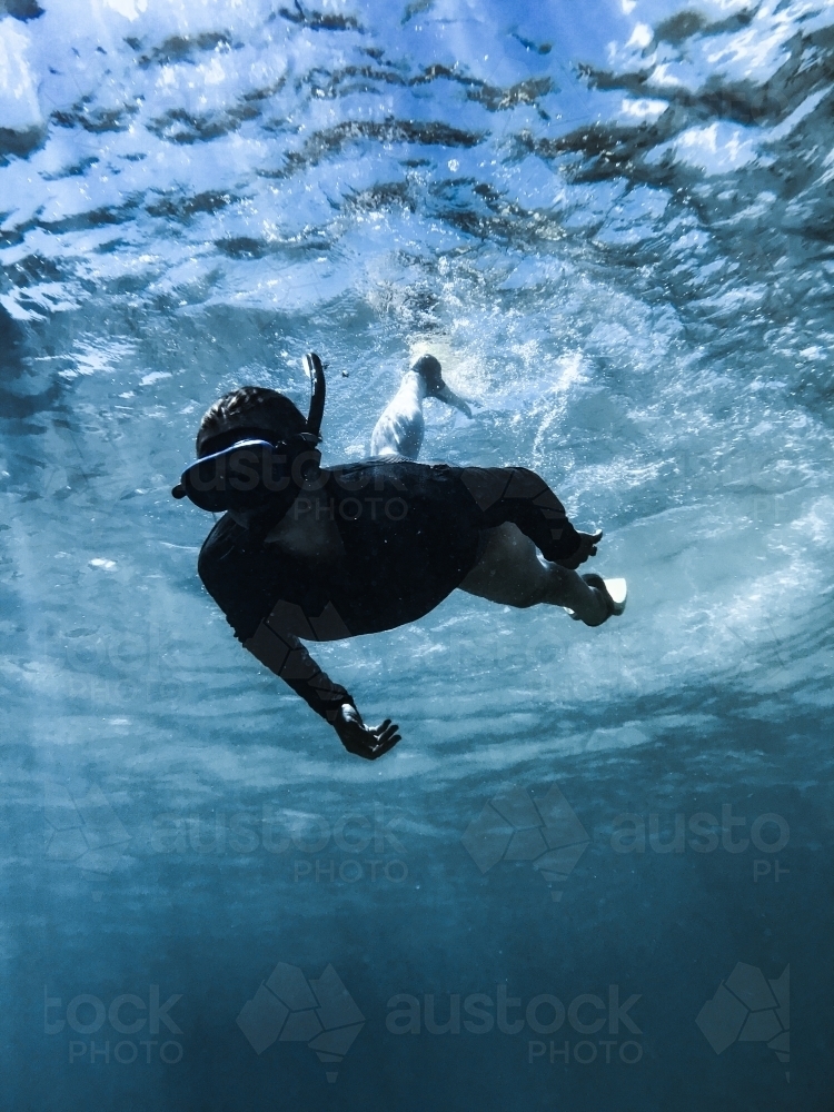 Woman snorkelling underwater in ocean - Australian Stock Image