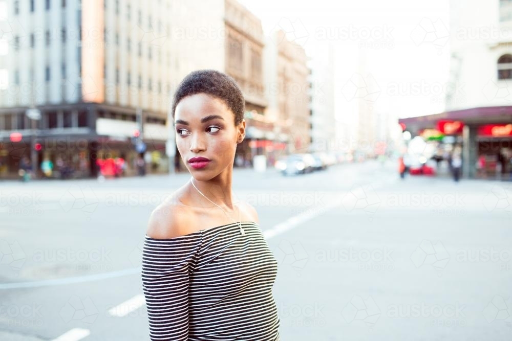 Woman standing on the street in the city - Australian Stock Image