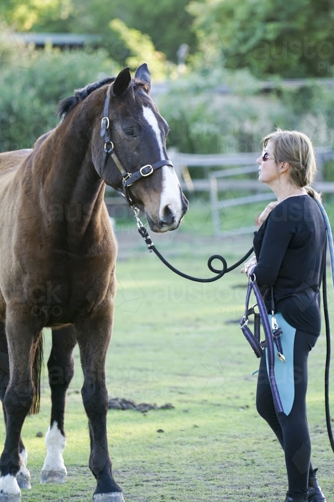 Woman standing with horse - Australian Stock Image