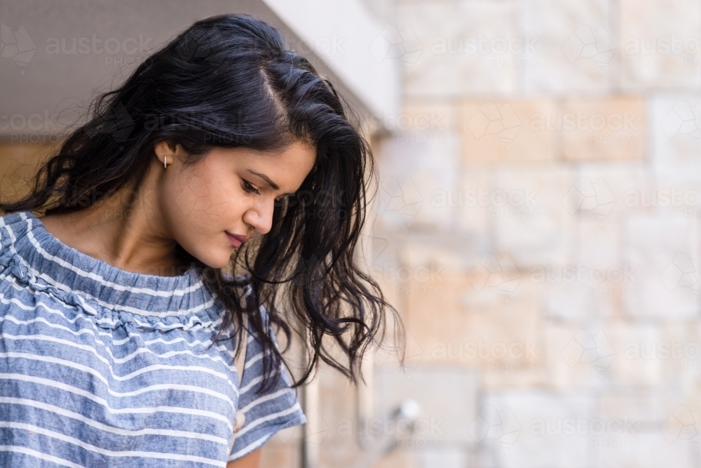 woman thinking and looking down - Australian Stock Image