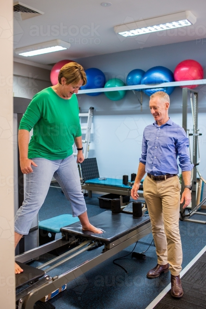 Image of Woman using physiotherapy equipment for strengthening