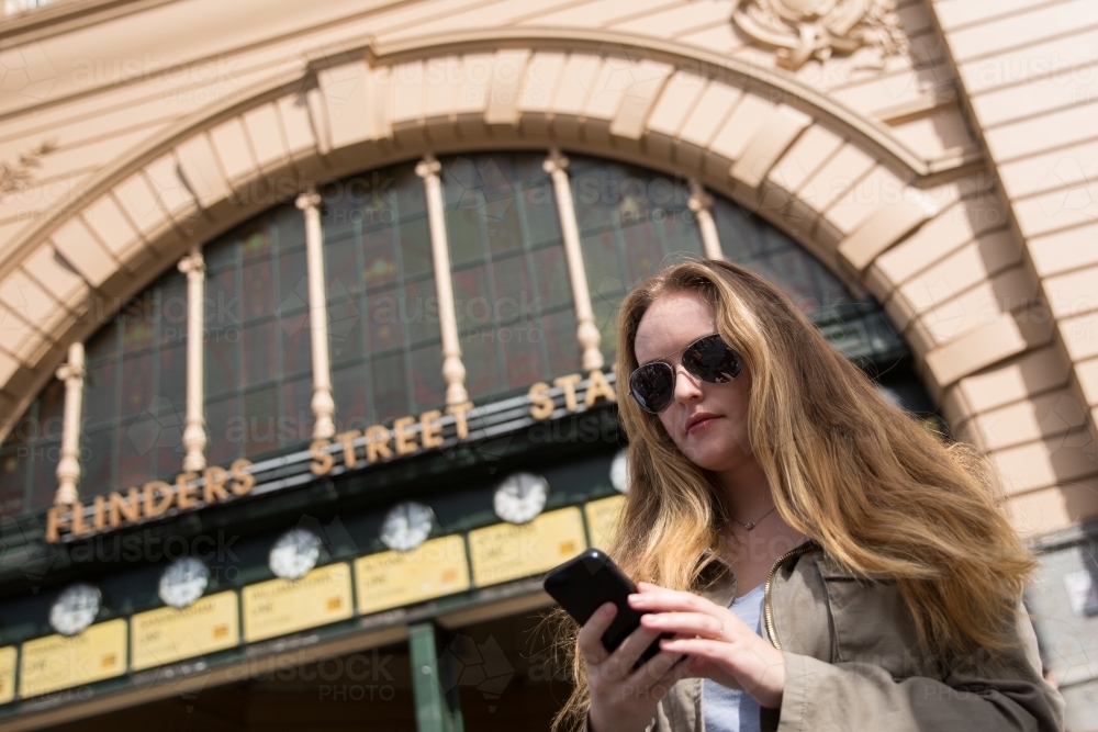 Woman waiting for Friends Under the Clocks - Australian Stock Image