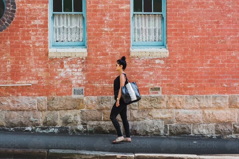 woman walking in urban area - Australian Stock Image