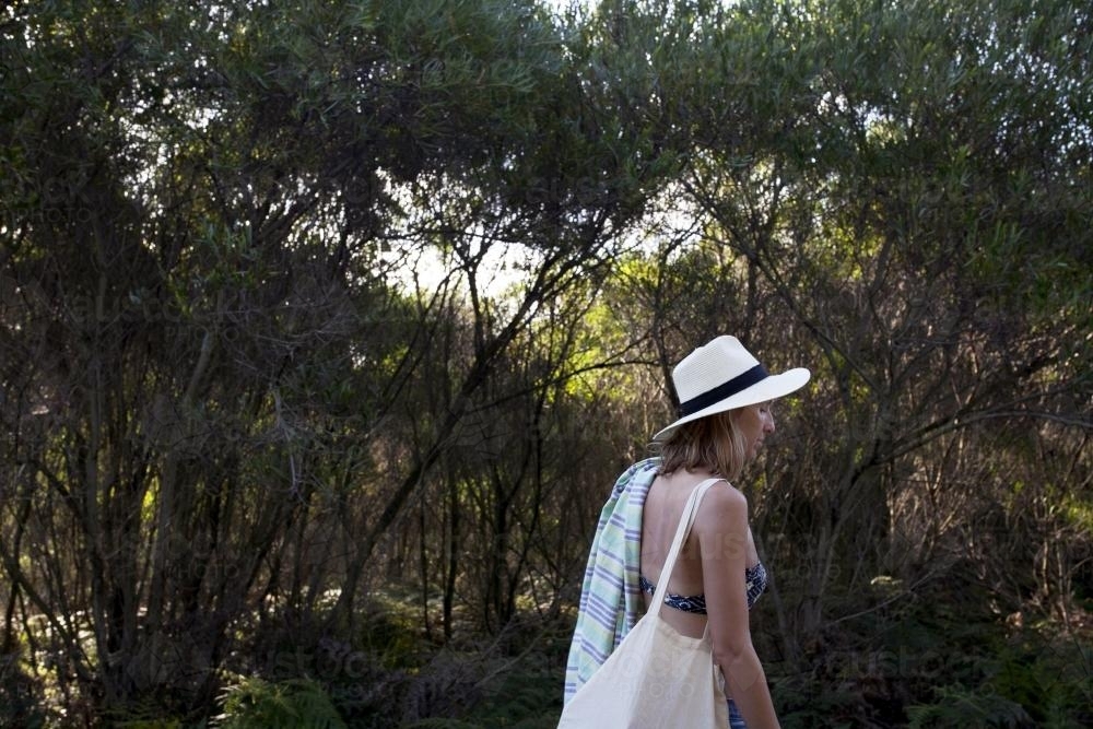 Woman walking through bush to the beach - Australian Stock Image