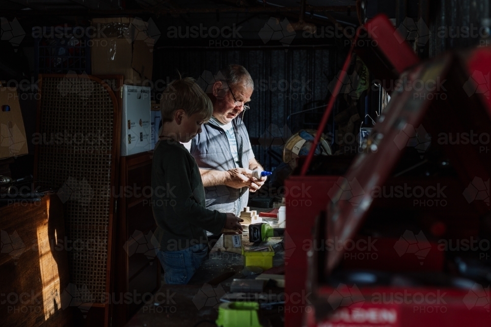 Woodworking with grandad in the shed - Australian Stock Image