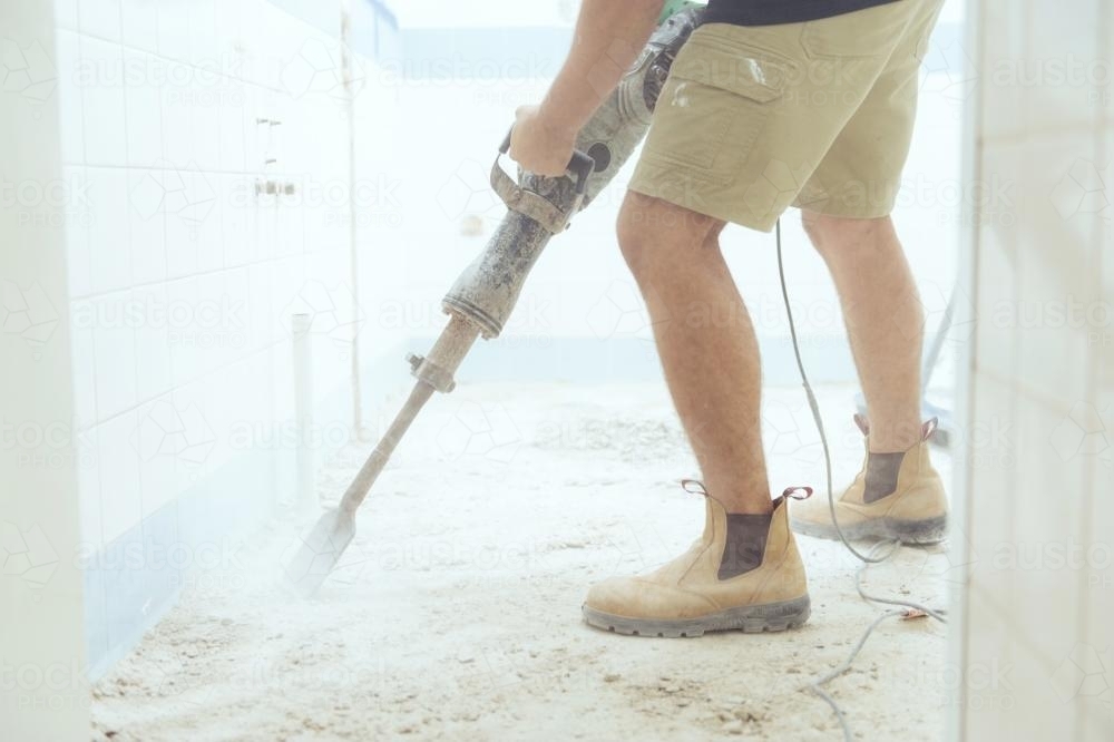 Workman jackhammering on construction site - Australian Stock Image