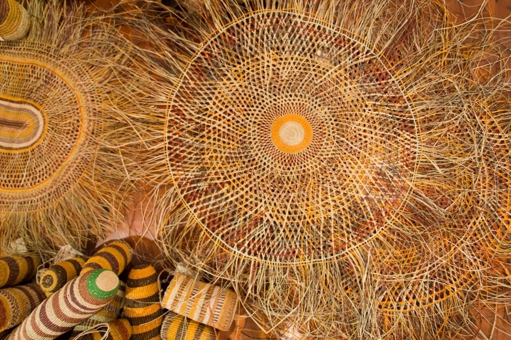 Woven baskets and mats with intricate patterns. - Australian Stock Image