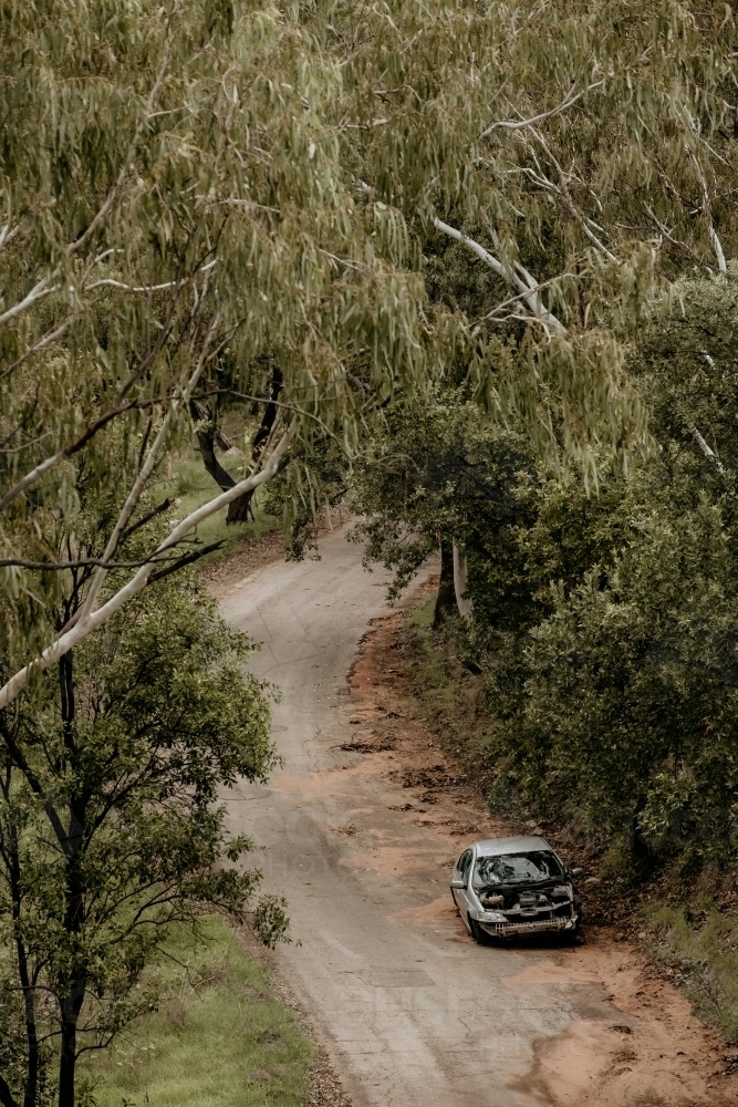 Image of Wrecked & abandoned car dumped on side road. - Austockphoto