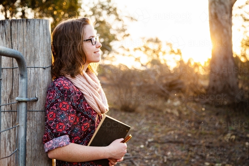 Writer with pen and journal finding inspiration in country - Australian Stock Image