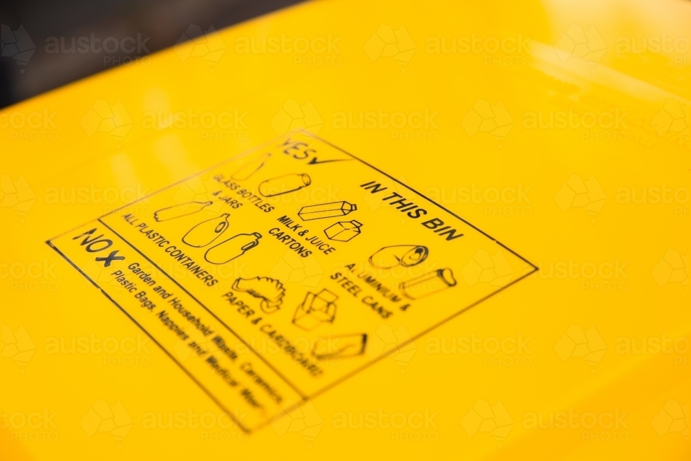 yellow recycling bin information on the lid - Australian Stock Image