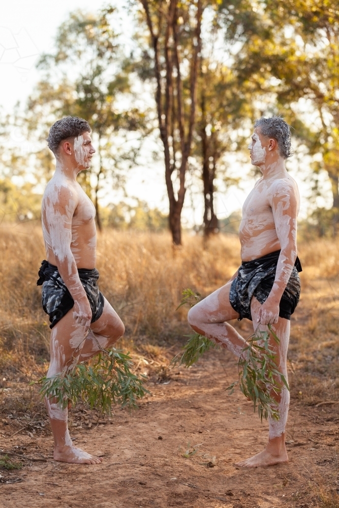 Young aboriginal Australians in their teens doing a dance on country in ochre body paint - Australian Stock Image