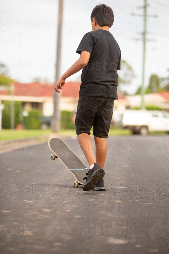 Young Aboriginal boy riding a skateboard - Australian Stock Image