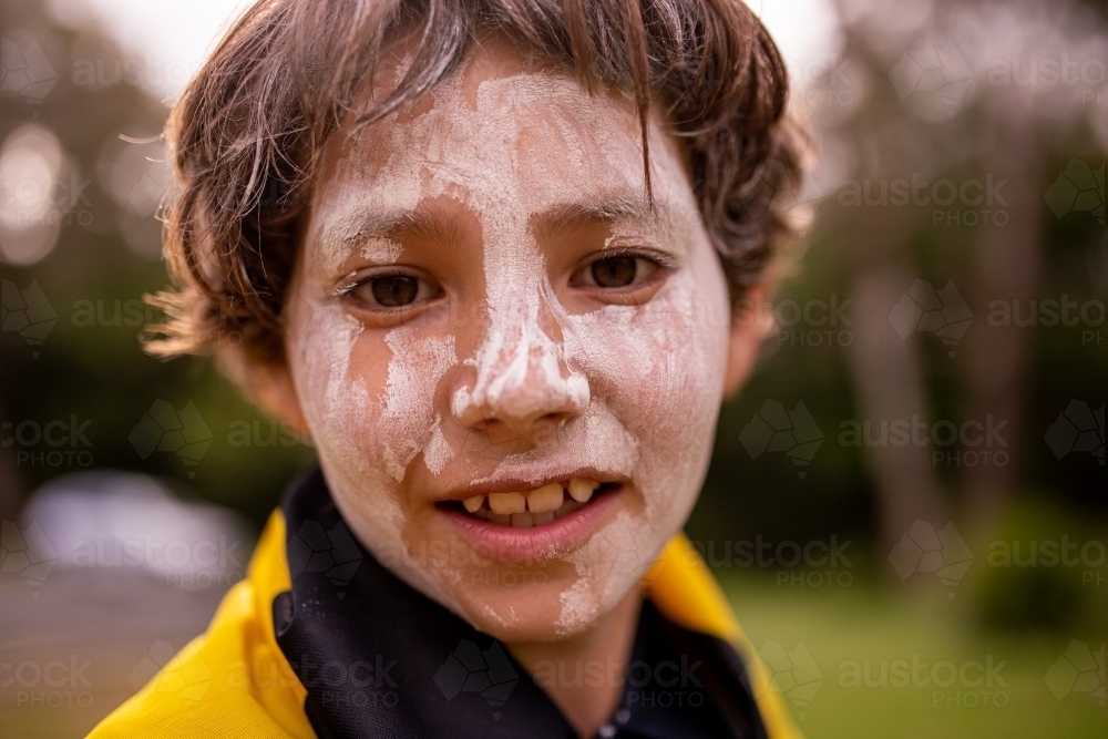 Young Aboriginal boy smiling at the camera - Australian Stock Image