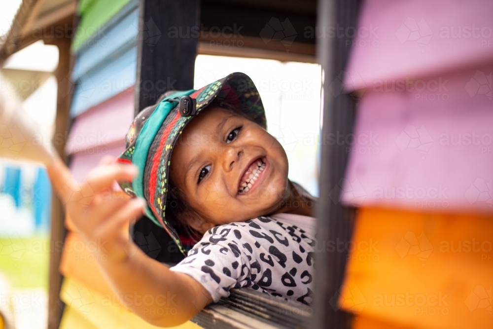 Young Aboriginal girl in a cubby house - Australian Stock Image