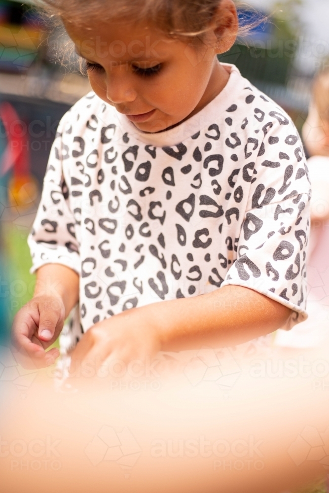 Young Aboriginal girl playing at preschool - Australian Stock Image