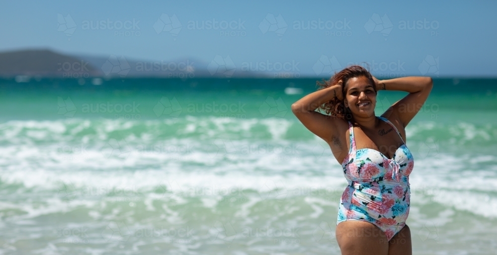 young aboriginal woman in swimsuit on the beach - Australian Stock Image