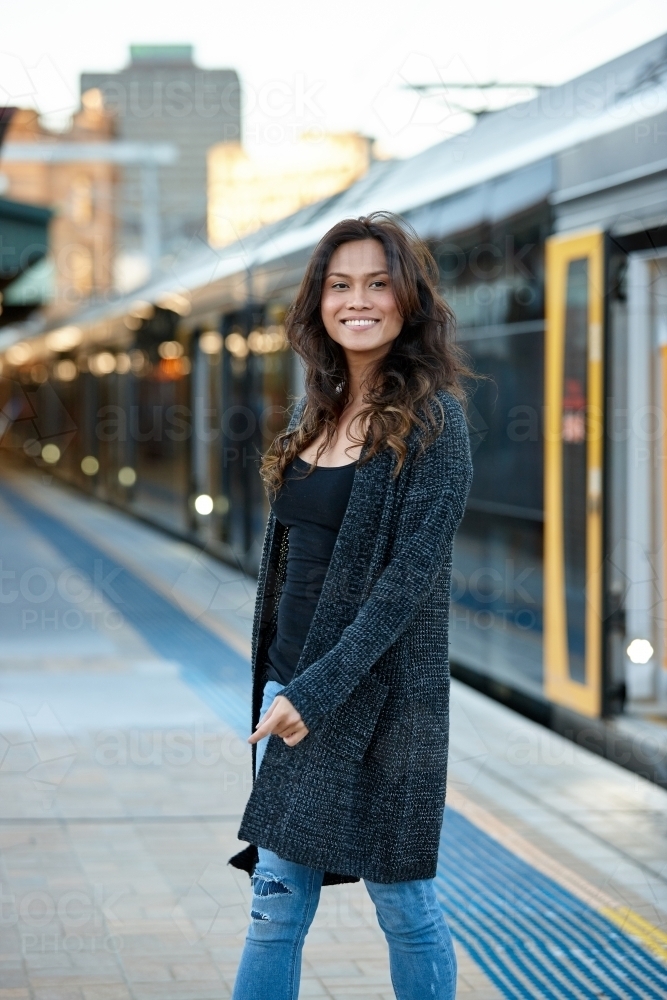 Young Asian woman waiting at train station - Australian Stock Image