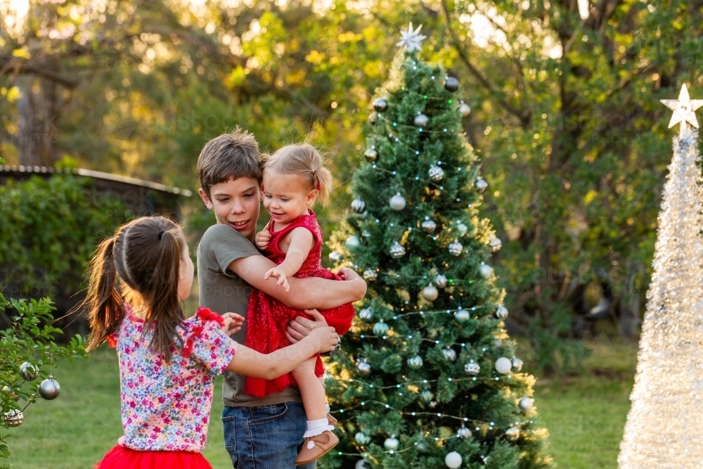 Image of Young Aussie cousins hug in greeting outside at Christmas ...