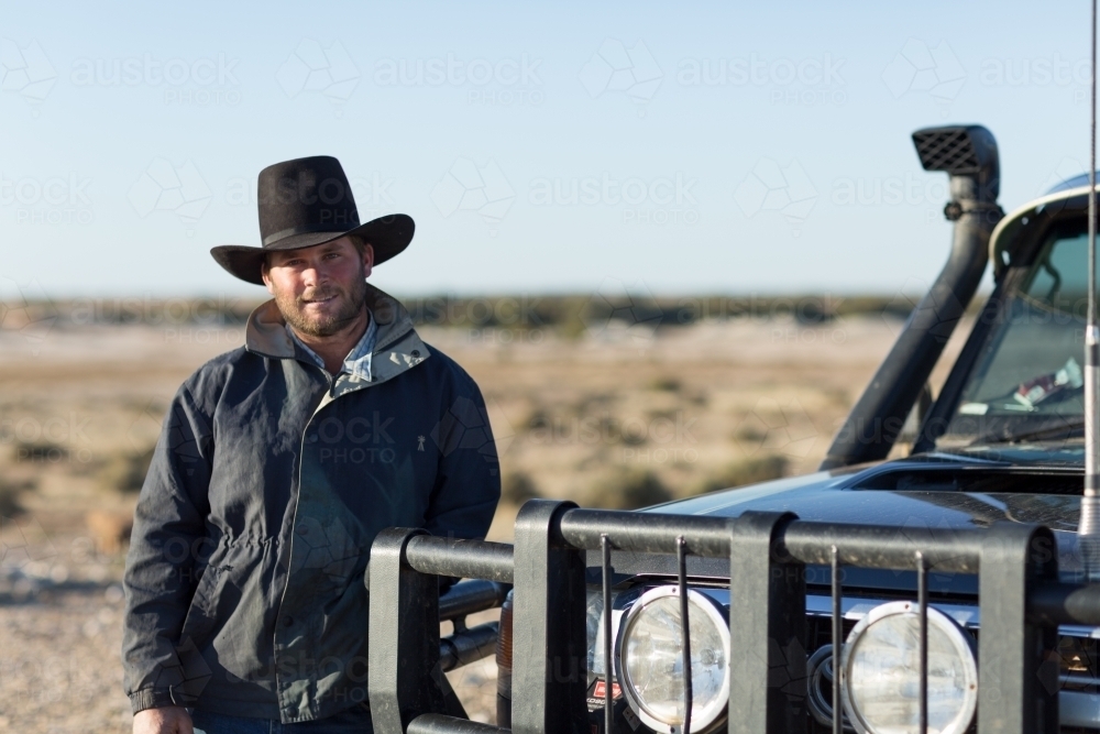 Young bloke in outback near vehicle with bullbar - Australian Stock Image