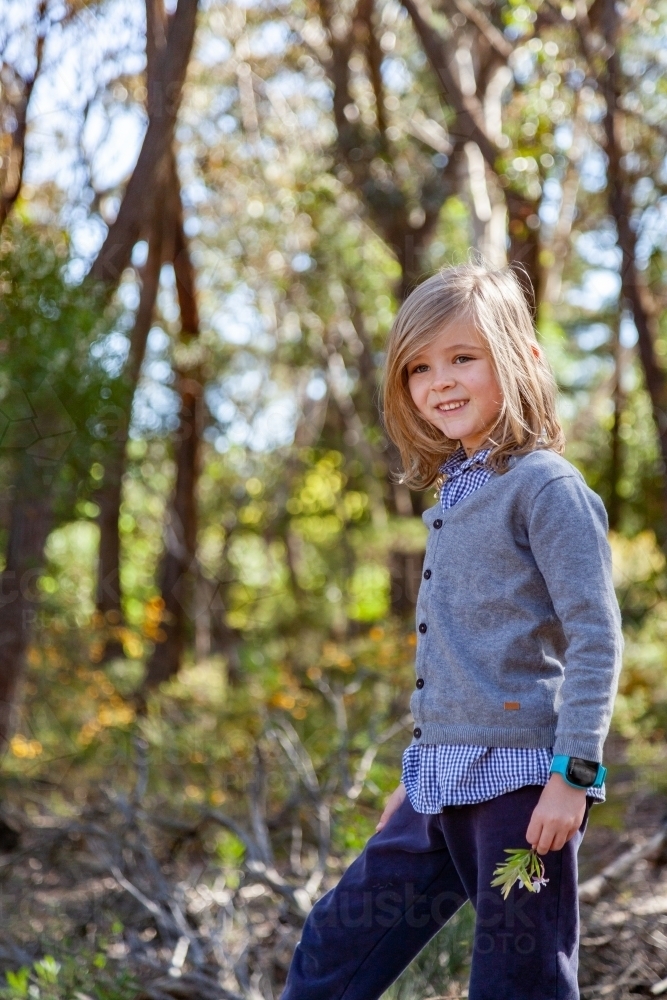 Image Of Young Boy With Long Blond Hair In Bushland Smiling