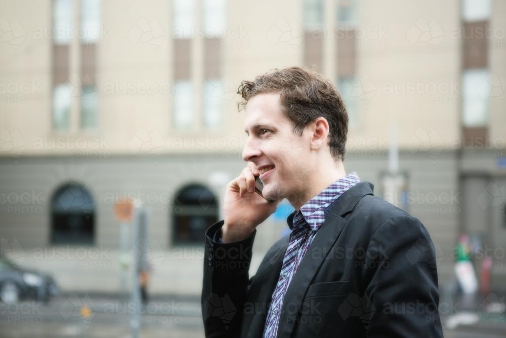 Young business man talking on mobile phone in CBD - Australian Stock Image