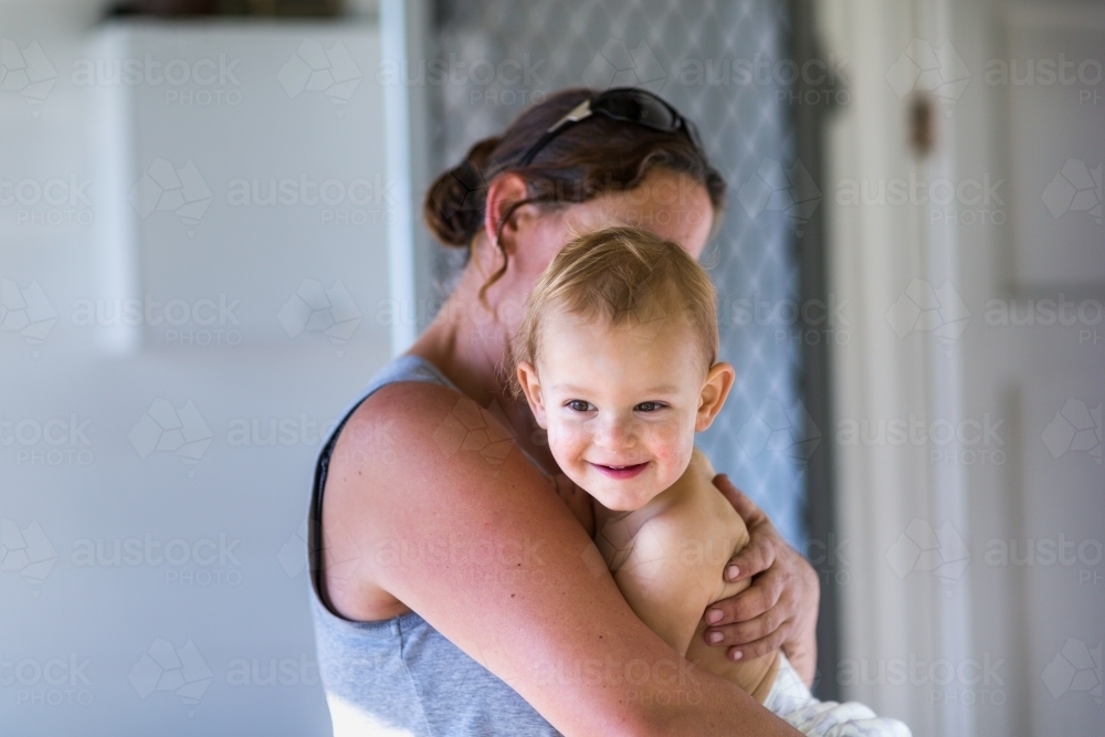 Young child in the arms of his mother - Australian Stock Image