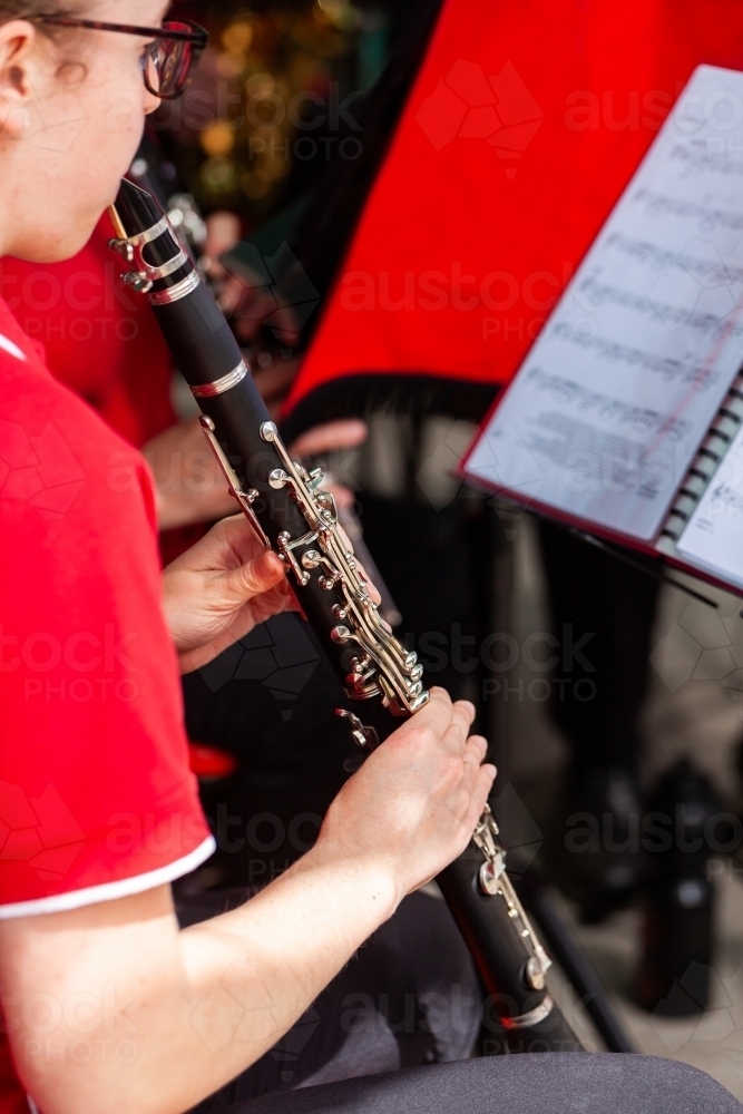 young clarinet player playing wind instrument with local town band at event - Australian Stock Image