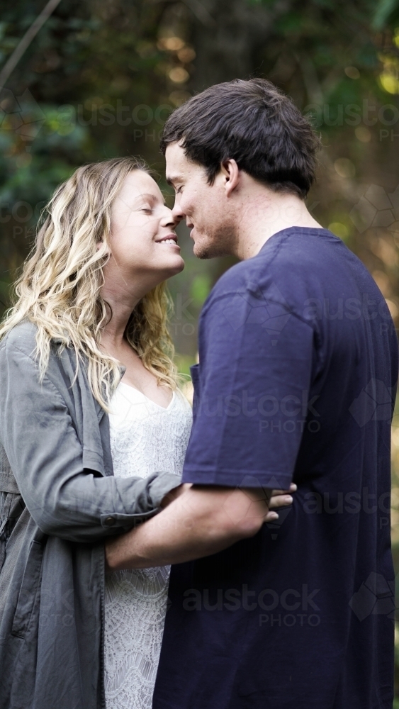 Young couple about to kiss, side profile - Australian Stock Image