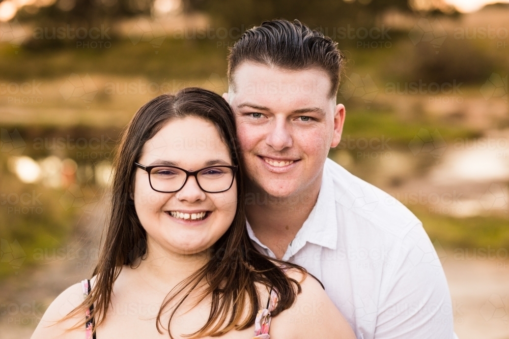 Young couple dating standing together happy smiling - Australian Stock Image