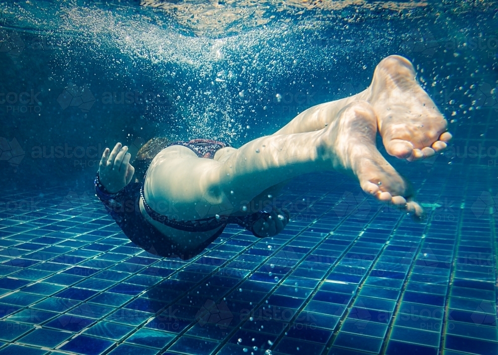 Young Girl Diving Under Water - Australian Stock Image